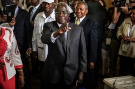FILE - Afonso Dhlakama shows his ink-stained finger after casting his ballot at a polling station in Maputo.