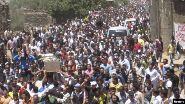 Syrians at a funeral in Daraa on Friday carry the body of a man who protesters say was killed by forces loyal to Syria's President Bashar al-Assad