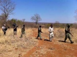 Some of Mander’s rangers on patrol with an American television crew in a wildlife park in Zimbabwe