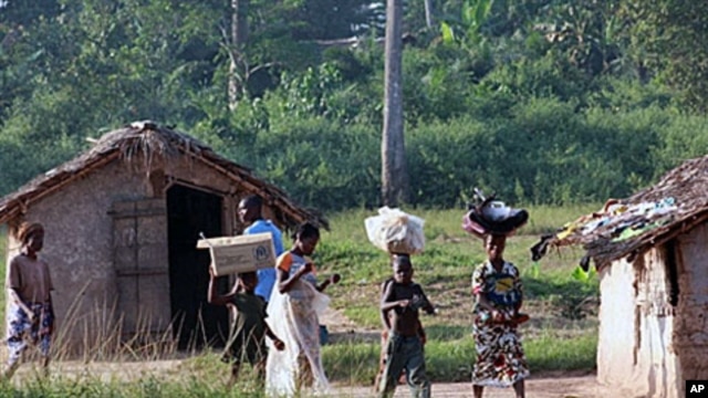 Ivorian refugees walk in the village of Loguatuo as many have flooded into Liberia, (File)