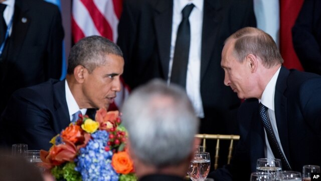 President Barack Obama and Russian President President Vladimir Putin greet each other during a luncheon, Monday, Sept. 28, 2015, at United Nations headquarters.