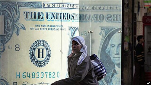 An Egyptian walks in front of a closed currency exchange office as banks, schools and the stock market remained closed for the second working day in Cairo, Egypt, January 31, 2011
