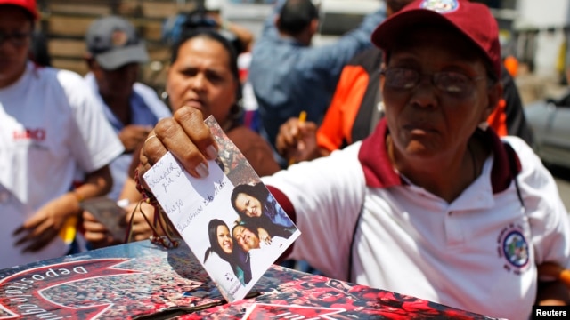 Supporters of Venezuelan President Hugo Chavez line up to put encouraging messages for him in a box outside the military hospital in Caracas Mar. 5, 2013.