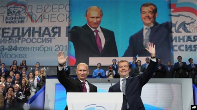 Russian President Dmitry Medvedev, right, and Prime Minister Vladimir Putin wave during a United Russia party congress in Moscow, September 24, 2011.
