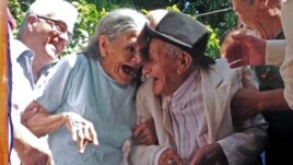 Paraguayan Anacleto Escobar (R) and his wife Cayetana Roman, smile during a ceremony coinciding with his 100th birthday in which they received a house.