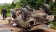 Seorang petugas berdiri di dekat truk yang hancur setelah melindas bom pinggir jalan di wilayah Saiburi, provinsi Pattani, Thailand (24/5). Dilaporkan lima tentara tewas dan satu terluka dalam insiden ini.