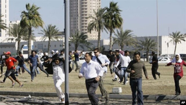 Bahraini anti-government protesters run for cover in Manama on February 19, 2011 after police fired tear gas to disperse them at Pearl Square