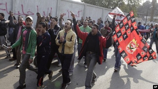 Fans from Al Ahly and Al Zamalek soccer teams chant slogans against the violence that occurred during a soccer match involving Al Ahly in Port Said, February 2, 2012