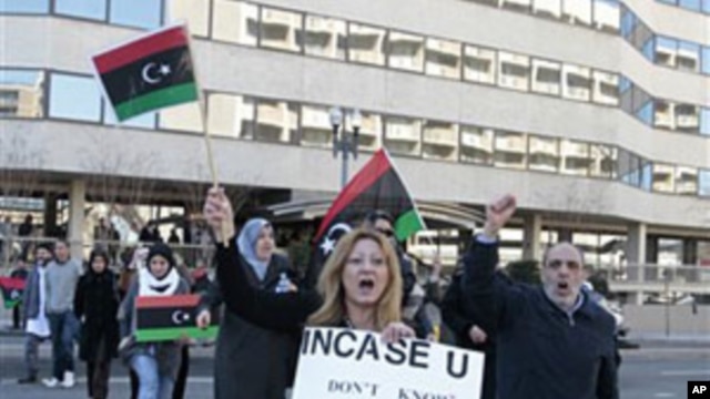 A small group of anti-Moammar Gadhafi protesters take part in a demonstration at the Libyan Embassy in Washington, March 1, 2011