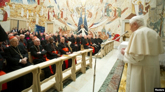 Pope Benedict XVI (R) speaks to Cardinals during the closing day of the Spiritual Exercises at the Vatican, February 23, 2013.  