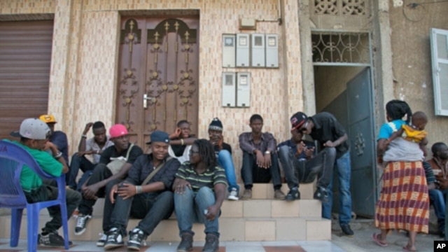 Rappers and musicians in Senegal's Y'en a Marre (We're Fed Up) coalition sit in Dakar while waiting to make a music video. 