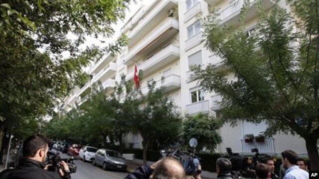 Media stand outside the Swiss Embassy after an explosion in Athens,  02 Nov 2010