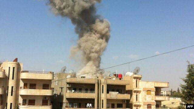 A handout picture released by the Syrian Arab News Agency (SANA) allegedly shows smoke rising as the state TV said a suicide car bomb rocked the Kurdish city of Qamishli, September 30, 2012.