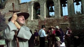 John Mione, playing Father Serra, looks skyward for swallows following the ringing of the bells in March 17 at the Mission San Juan Capistrano