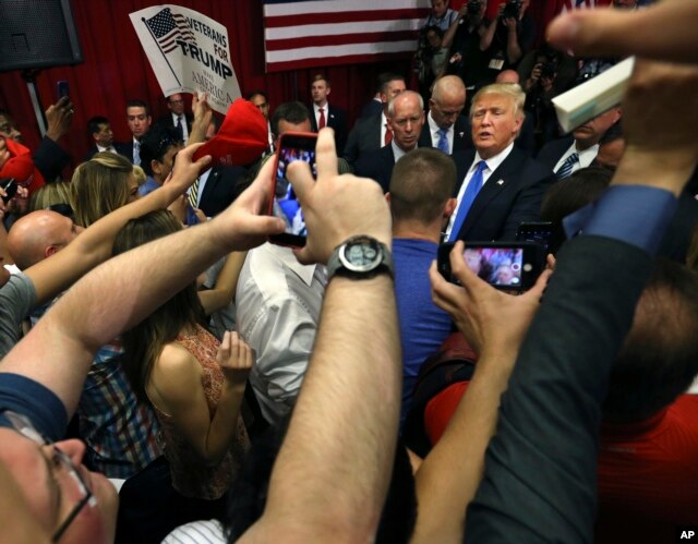 Republican presidential candidate Donald Trump, center right, greets supporters after speaking at a campaign event, May 19, 2016 in Lawrenceville, N.J.