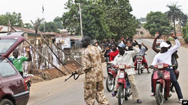 A soldier searches a car in Kaduna, Nigeria, April 21, 2011