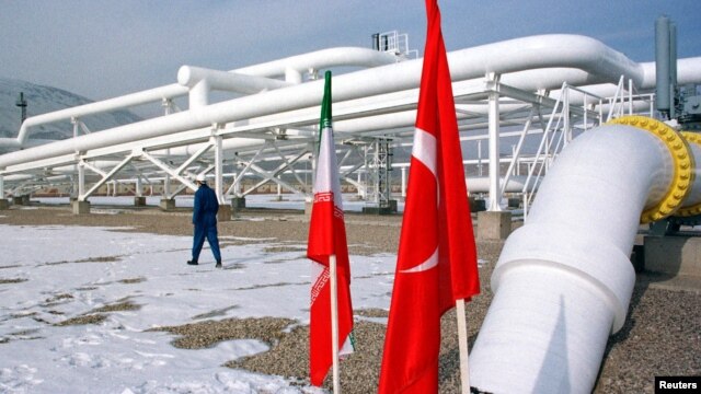 A worker walks past the pumping station on the border between Iran and Turkey during the inauguration ceremony for the Iran-Turkey gas pipeline, January 22, 2002. 