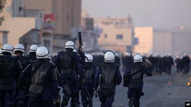 Riot police chase Bahraini anti-government protesters in the Shiite Muslim village of Sitra, Bahrain, January 1, 2012.