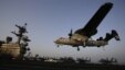 FILE - An aircraft lands after missions targeting the Islamic State group in Iraq from the deck of the U.S. Navy aircraft carrier USS George H.W. Bush in the Persian Gulf, Aug. 10, 2014.