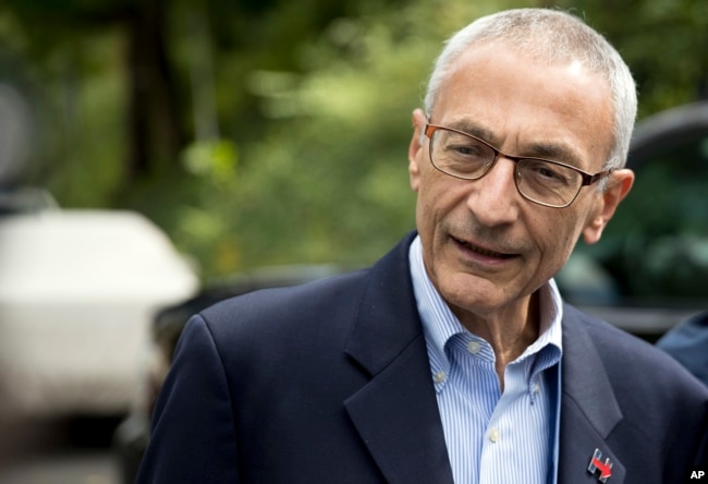 FILE - Hillary Clinton campaign chairman John Podesta speaks to reporters outside Clinton's home in Washington, Oct. 5, 2016.