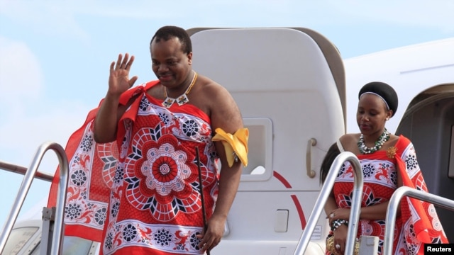 King of Swaziland Mswati III (left) and one of his 13 wives disembark from a plane after arriving at Katunayake International airport in Colombo, Sri Lanka, August 13, 2012. (Reuters)