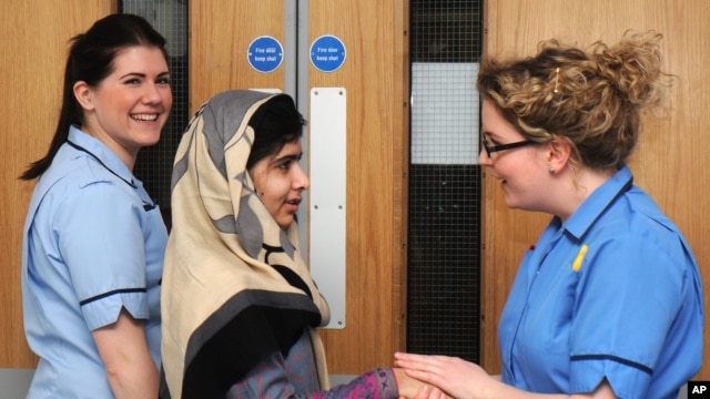 This photo made available by Queen Elizabeth Hospital shows Malala Yousafzai saying goodbye as she is discharged from the hospital to continue her rehabilitation at her family’s temporary home, Birmingham, England, Jan. 4, 2013.
