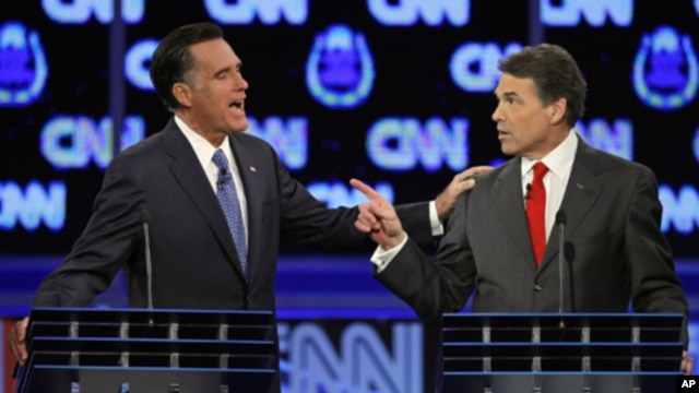 Republican presidential candidates former Massachusetts Gov. Mitt Romney, left, and Texas Gov. Rick Perry argue during a Republican presidential debate in Las Vegas, October 18, 2011.