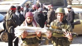 Free Syrian Army fighters transport ammunition which was seized from government forces' Wadi al-Daif military base at Maaret al-Numan, in the Idlib governorate in the northwest of Syria, December 29, 2012.