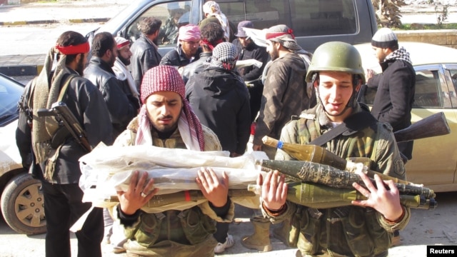 Free Syrian Army fighters transport ammunition which was seized from government forces' Wadi al-Daif military base at Maaret al-Numan, in the Idlib governorate in the northwest of Syria, December 29, 2012.