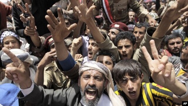 Anti-government protesters shout slogans during a rally to demand the ouster of Yemen's President Ali Abdullah Saleh outside Sana'a University, April 1, 2011
