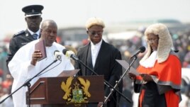 Ghanaian President John Mahama is sworn-in by Chief Justice Georgina Wood (R) at Independence Square, Accra, January 7, 2013. 