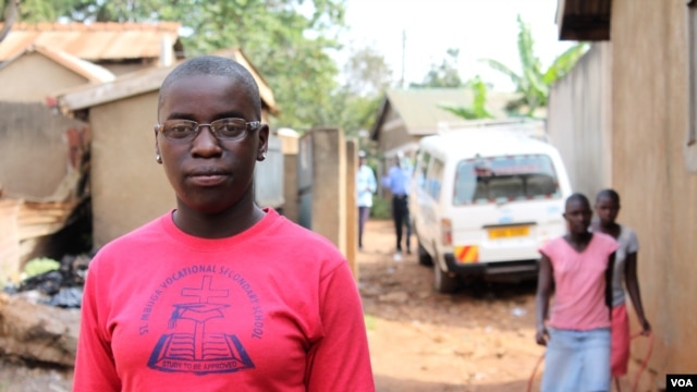 Phiona Mutesi stands near where she grew up in Katwe slum, Kampala, Uganda, January 28, 2012. (H. Heuler/VOA)