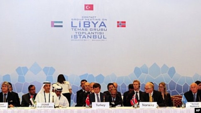 Fatih Mohammed Baja (L), Advisor of Political Affairs to Head of National Transitional Council of Libya, Khalid Al Ghaith (2nd L), United Arab Emirates (UAE) Assistant Minister for the Department of Economic Affairs, Turkish Foreign Minister Ahmet Davutog