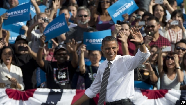 President Barack Obama waves to the crowd as he arrives to speak at a campaign event, Nov. 1, 2012, at the Cheyenne Sports Complex in Las Vegas.