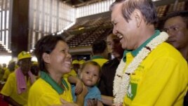 Human Rights Party President Kem Sokha, right, greets a party member as he attends the new party's congress in Phnom Penh. 