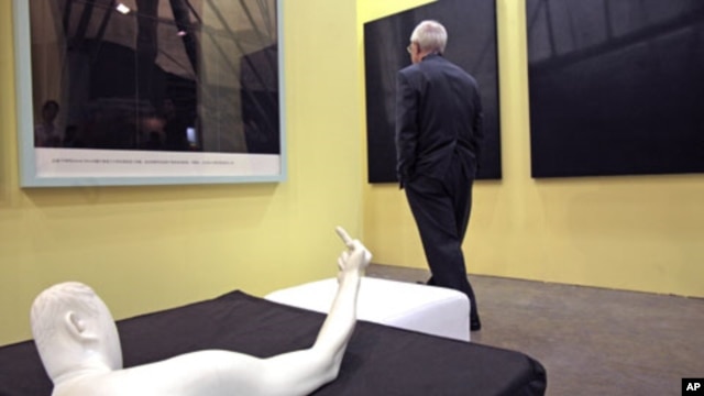 A man walks past the sculpture titled "Marble Arm" by Chinese dissident artist Ai Weiwei at Hong Kong International Art Fair, May 25, 2011