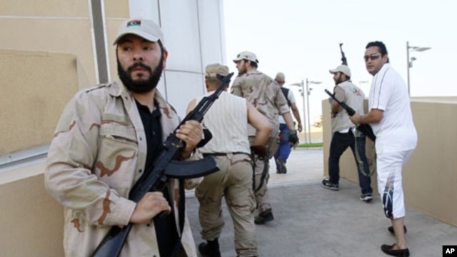 Libyan rebels patrol to try to find any of Moammar Gadhafi's relatives in Tripoli, Libya, August 24, 2011