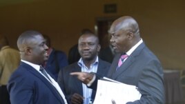 Roger Lumbala (R), a former member of parliament in the Democratic Republic of Congo who joined the M23 rebel group, chats with colleagues shortly after attending a peace talk meeting in Uganda's capital Kampala, January 11, 2013.