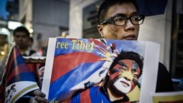 Rights group activists stage a protest to raise awareness on the human rights situation in Tibet and the closure of the territory to foreign visitors, outside the Chinese liaison office in Hong Kong, June 20, 2012. 
