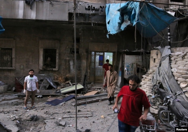 Medics inspect the damage outside a field hospital after an airstrike in the rebel-held al-Maadi neighbourhood of Aleppo, Syria, Sept. 28, 2016.