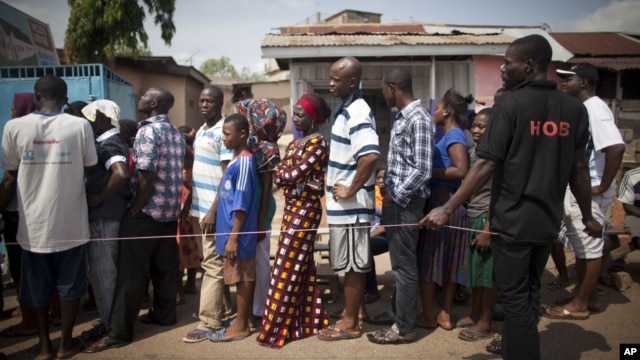 People wait in line to vote during an unexpected second day of balloting at a polling station near Accra, Ghana, Dec. 8, 2012.