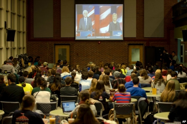 Students view on a video screen the Democratic presidential debate between candidates Senator Bernie Sanders of Vermont and former Secretary of State Hillary Clinton at University of New Hampshire in Durham, N.H., Feb. 4, 2016.