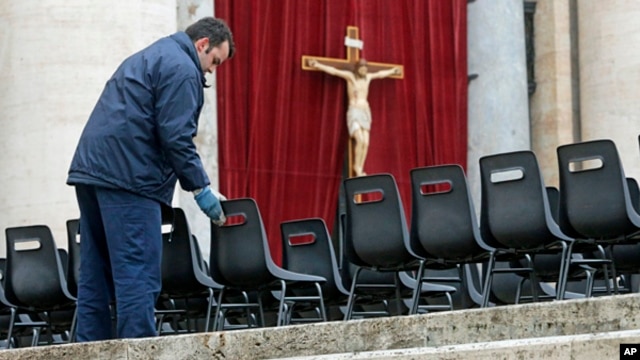 Workers install chairs in St. Peter's Square at the Vatican,  March 18, 2013 for Pope Francis' Installation Mass on Tuesday. 
