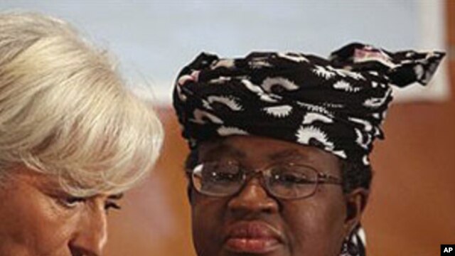 International Monetary Fund Managing Director Christine Lagarde, left, and Nigeria's Finance Minister Ngozi Okonjo-Iweala confer during roundtable meeting with Nigerian business executives in Lagos, Nigeria.
