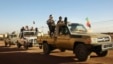 Soldiers from the Tuareg rebel group MNLA drive in a convoy of pickup trucks in the northeastern town of Kidal, Mali, February 4, 2013. 