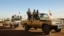Soldiers from the Tuareg rebel group MNLA drive in a convoy of pickup trucks in the northeastern town of Kidal, Mali, February 4, 2013. 