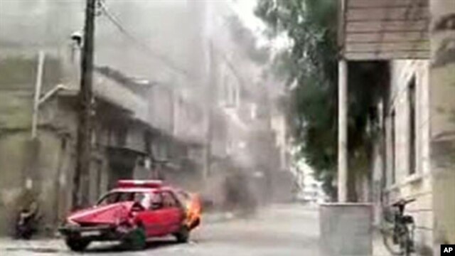 An image grab taken from a video posted on YouTube shows a police car burning during an anti-regime protest in the central city of Homs, May 20, 2011