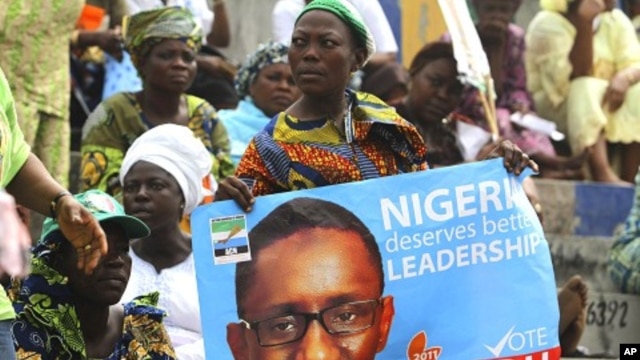 A supporter holds a poster campaigning for former anti-graft chief Nuhu Ribadu during the presidential primaries of ACN in Lagos, 14 Jan 2011
