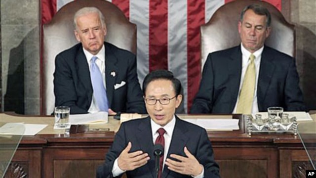 South Korean President Lee Myung-bak speaks to a joint meeting of Congress as Vice President Joe Biden (L) left, and Speaker of the House John Boehner (R) look on at the Capitol in Washington, October 13, 2011.