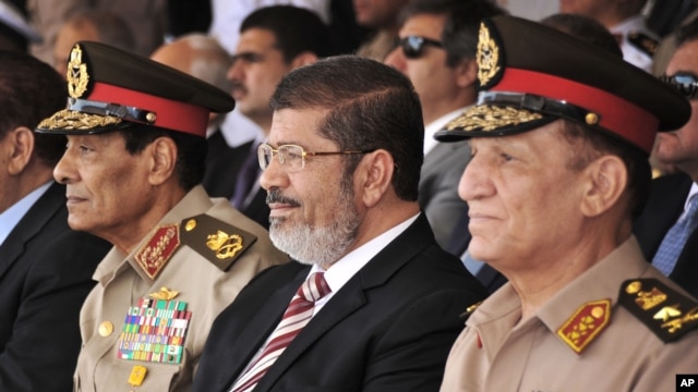 Egyptian Field Marshal Gen. Hussein Tantawi (l) President Mohammed Morsi, center, and Armed Forces Chief of Staff Sami Anan, right, July 5, 2012.